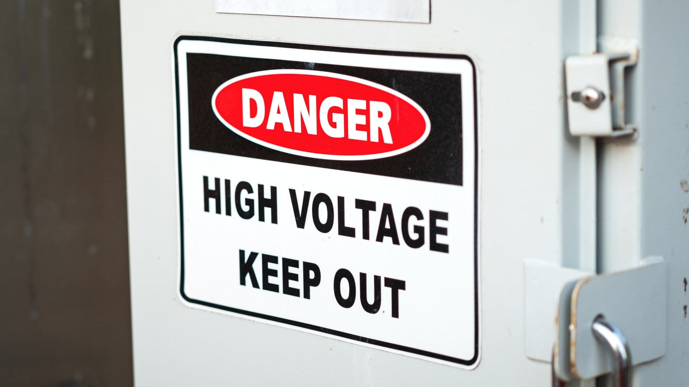 Electrical panel with high voltage warning sign and padlock